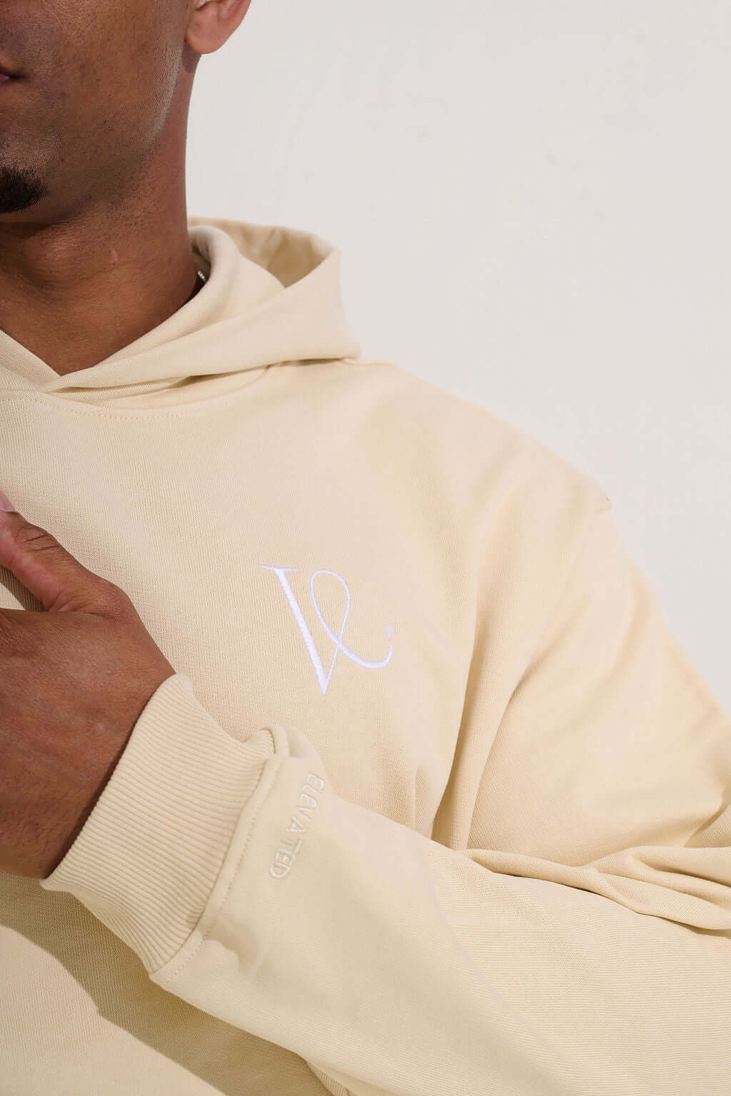 Close-up of the embroidered chest monogram and tone on tone cuff lettering - KAVEON